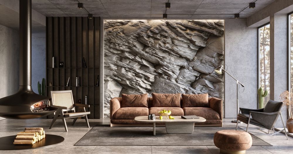 Modern living room with rock wall backdrop, brown sofa, fireplace, and chairs.