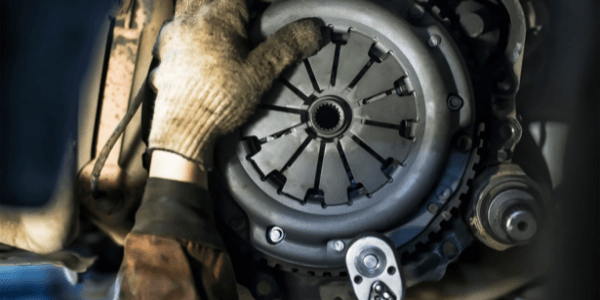 The hands of a mechanic performing a Clutch replacement in Hastings