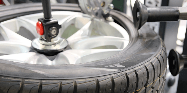 A tyre being put through the fitting process onto an alloy wheel by a Hastings mechanic