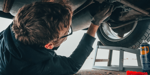 The hands of a mechanic performing a Car repair in Hastings