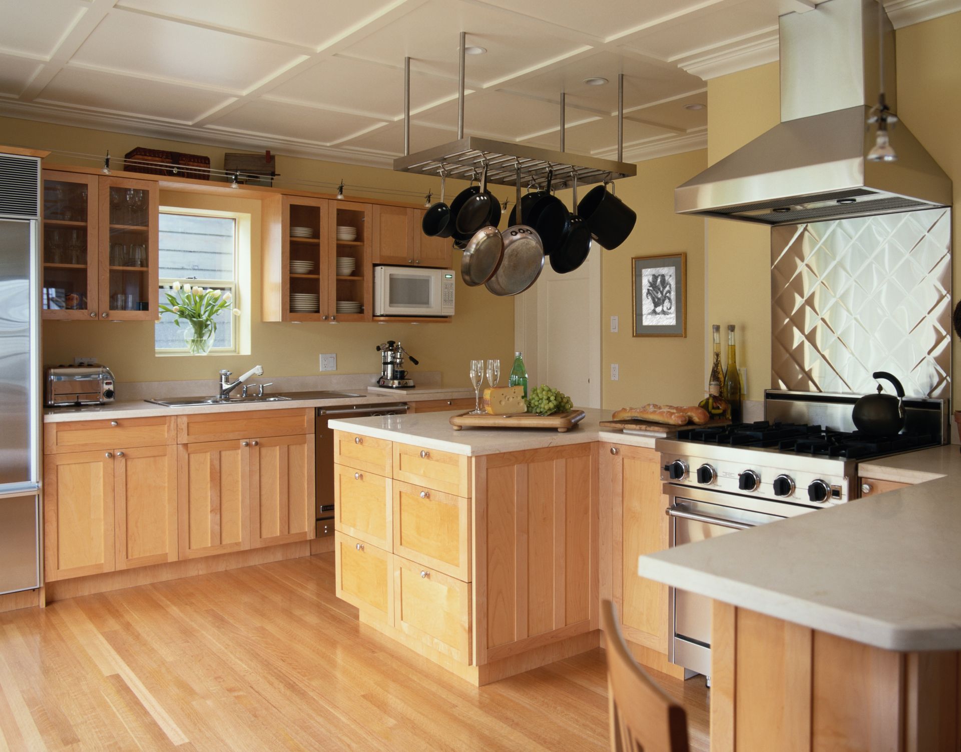 A kitchen with pots and pans hanging from the ceiling