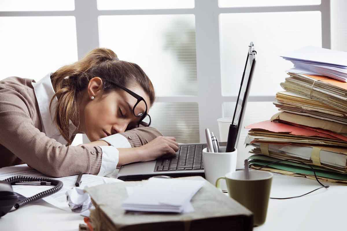 Napping At School and The Science of The Chronobiology: A girl lays her head on her computer to sleep after a long days work