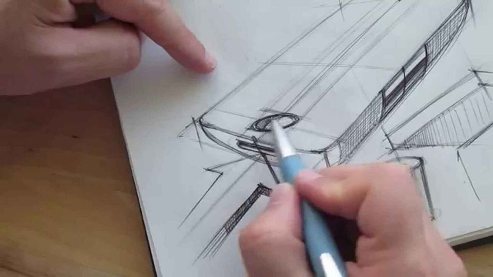 A person sketching a prototype for a phone with a pen and paper