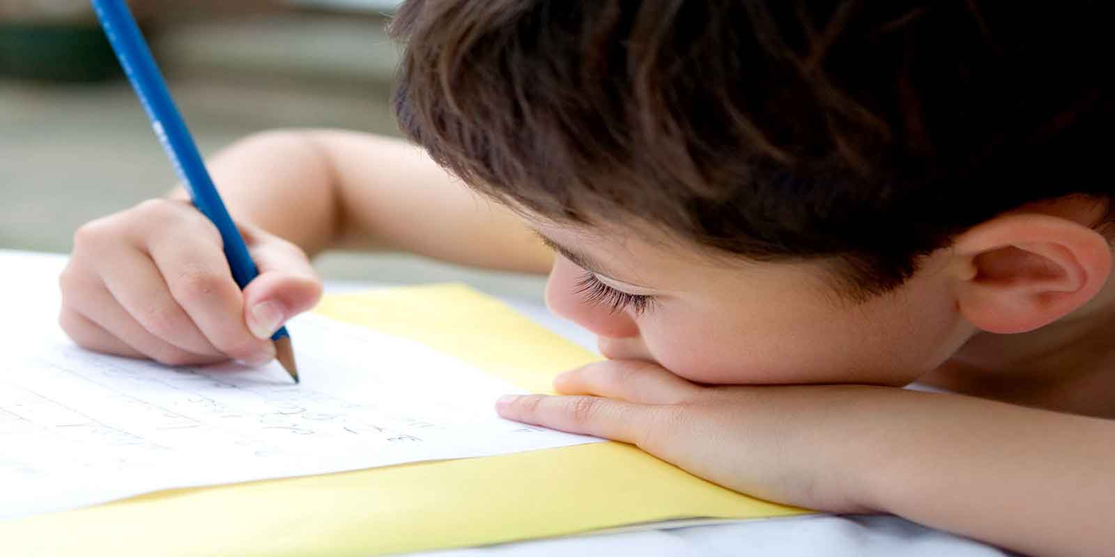 A child using a pen and paper to refine his motor skills