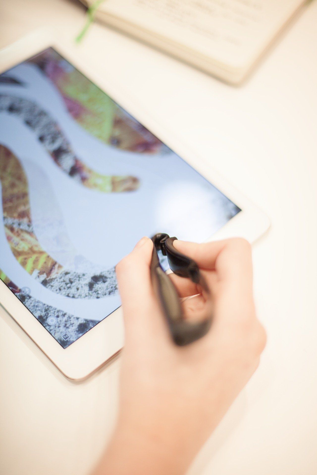 A picture of someone using a scriba stylus to draw on their touchscreen device
