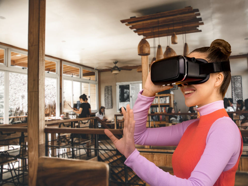 Woman wearing VR headset in cafe