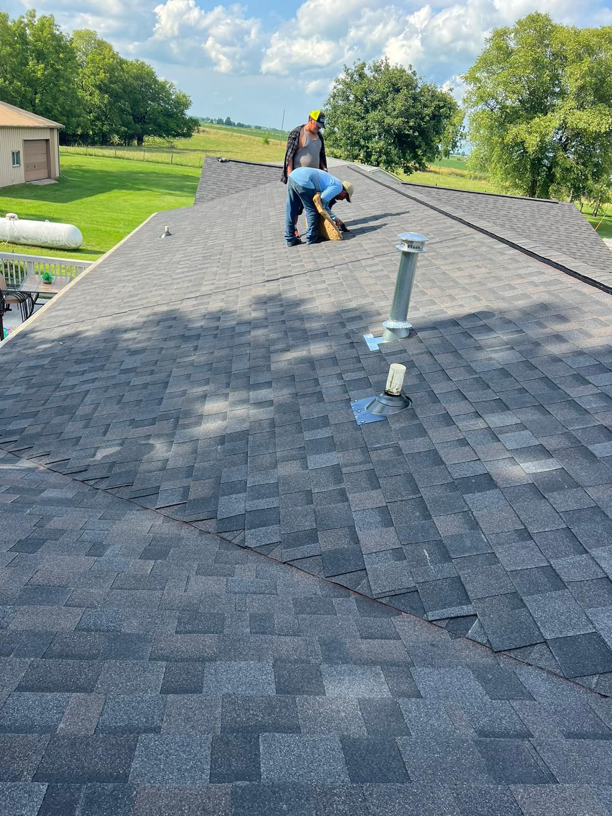 A man is working on the roof of a house.