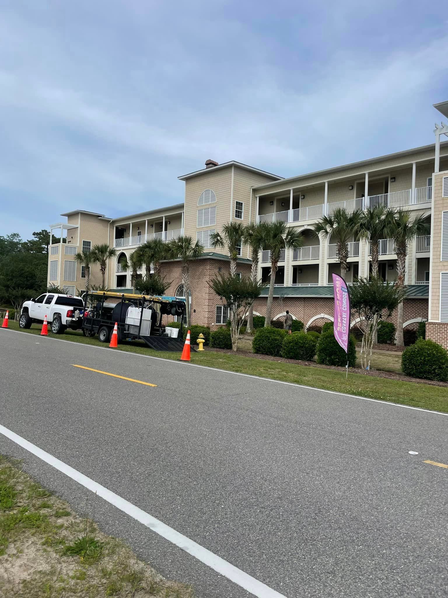 A Large Building With A Golf Cart Parked — Leland, NC — Coastal Exterior Solutions