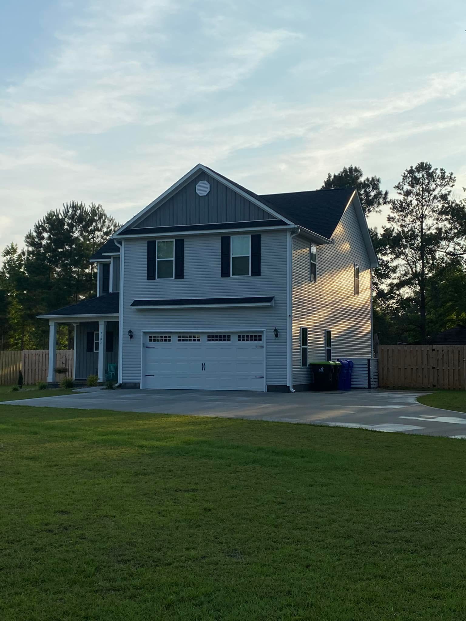 A White House With A Blue Roof Sits — Leland, NC — Coastal Exterior Solutions