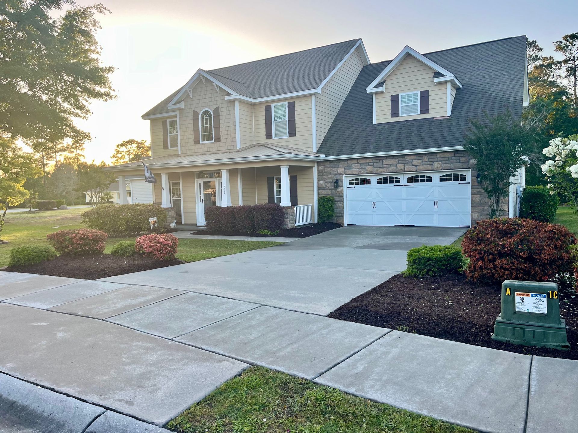 A Large House With A Garage Door — Leland, NC — Coastal Exterior Solutions