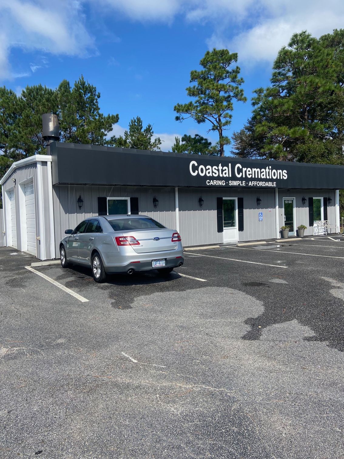 A Car Is Parked In Front Of A Building — Leland, NC — Coastal Exterior Solutions