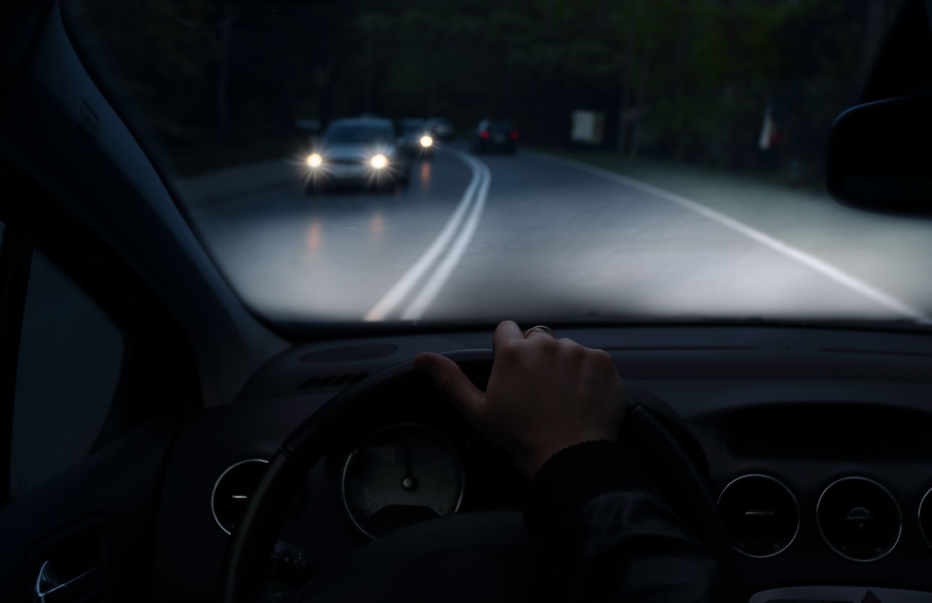 A person is driving a car on a dark road at night | Buckley's Auto Care - Millsboro, DE