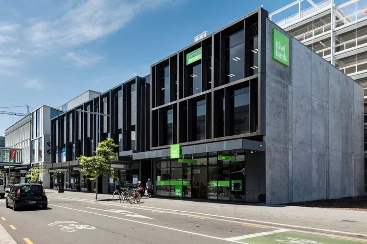 Modern building with black frames, green accents, and the