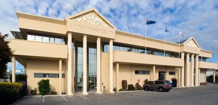 Two-story building: restaurant/bar on ground floor, dark gray facade, glass balcony, street view.