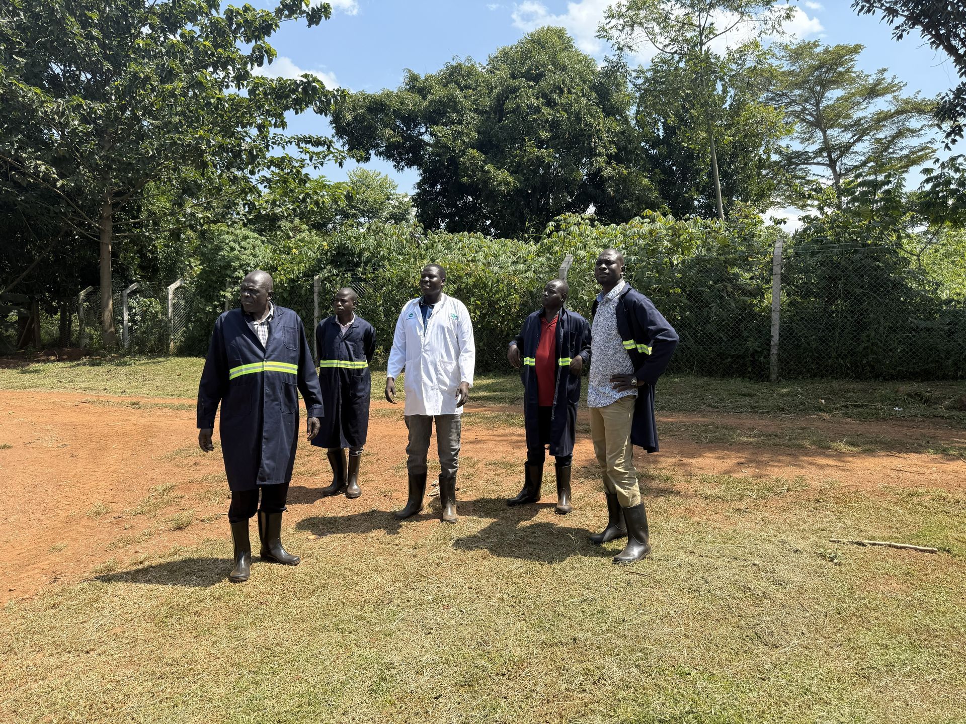 Community members standing together outside a rural home.