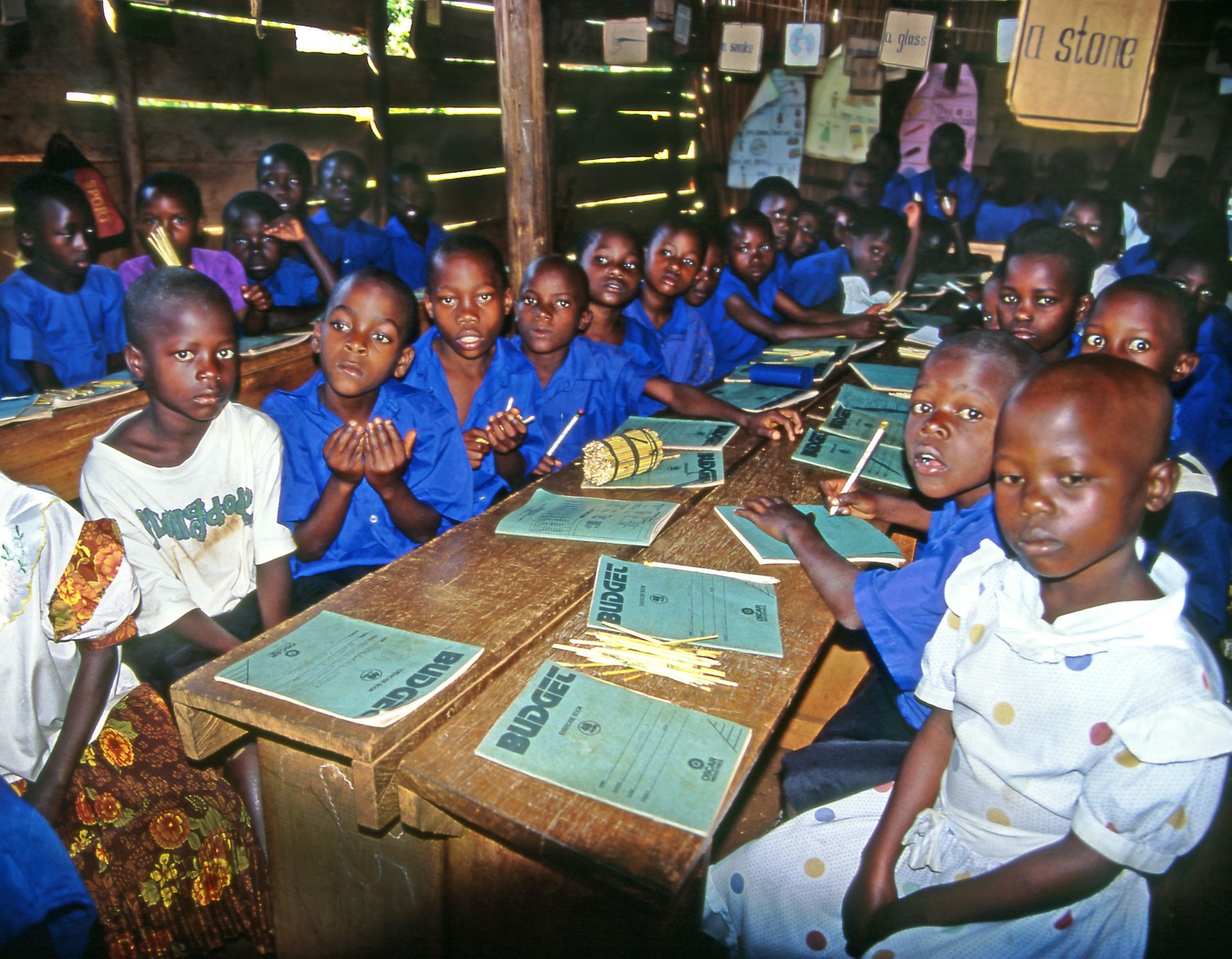 Children in a classroom with school supplies.