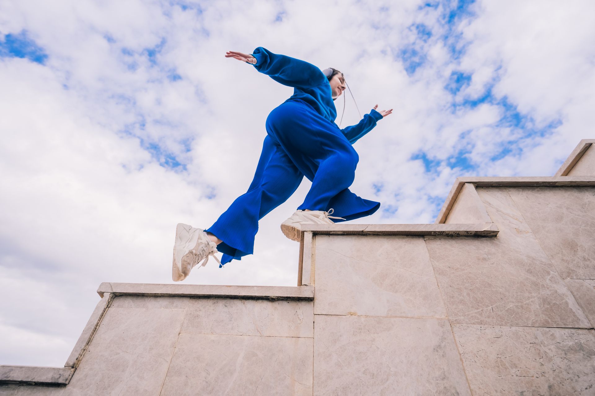 A person is jumping over a set of stairs.
