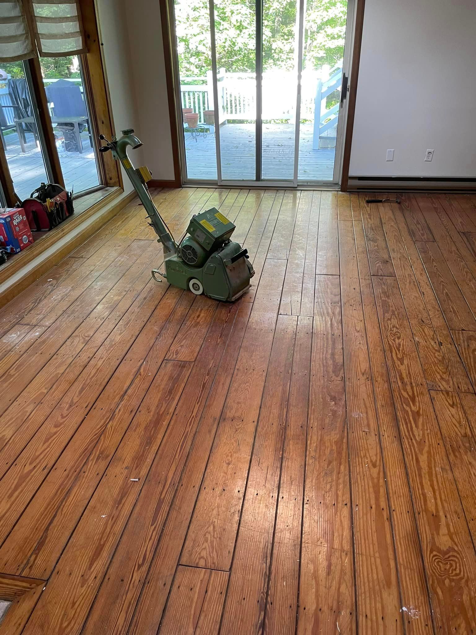 A machine is sitting on a wooden floor in a room.