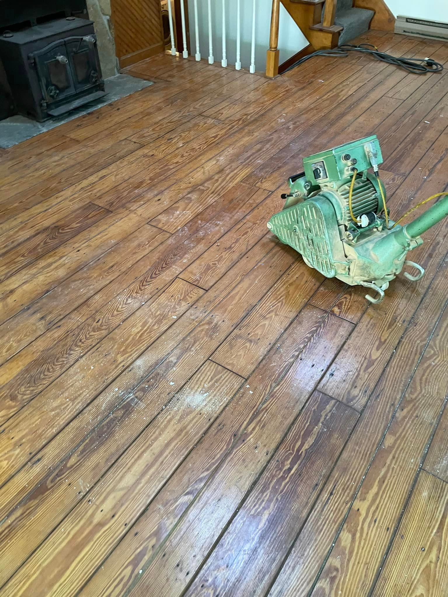 A machine is sitting on a wooden floor in a room.