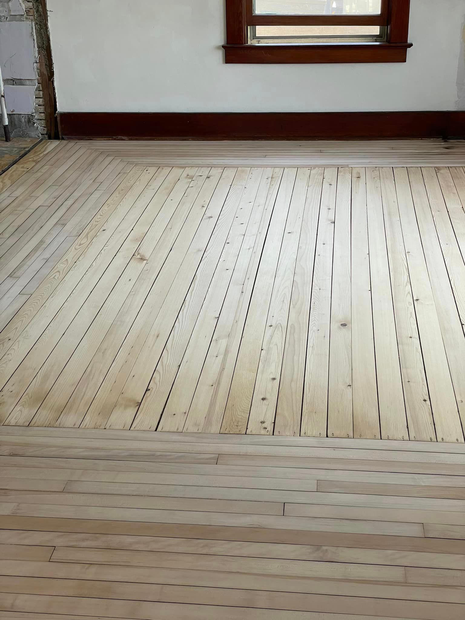 A room with a wooden floor and a window