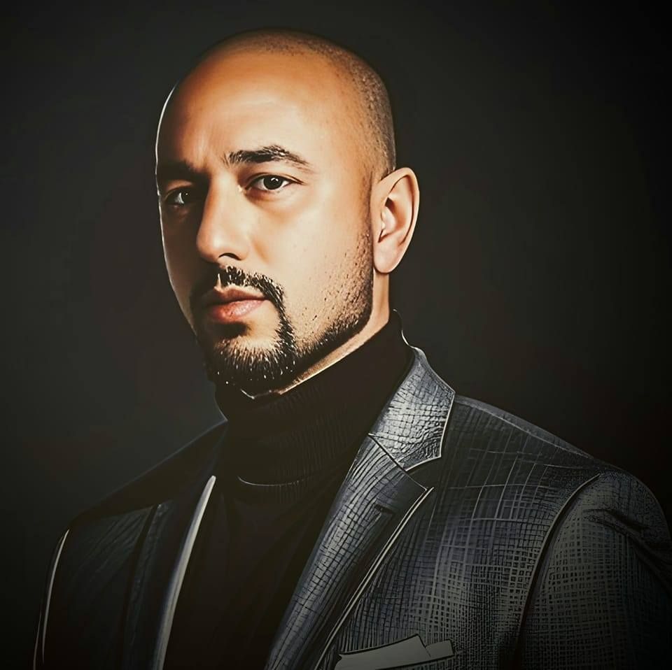 Aaron Escobedo CEO of Boiga Digital Marketing. A man in a sleek grey suite with a stern look.