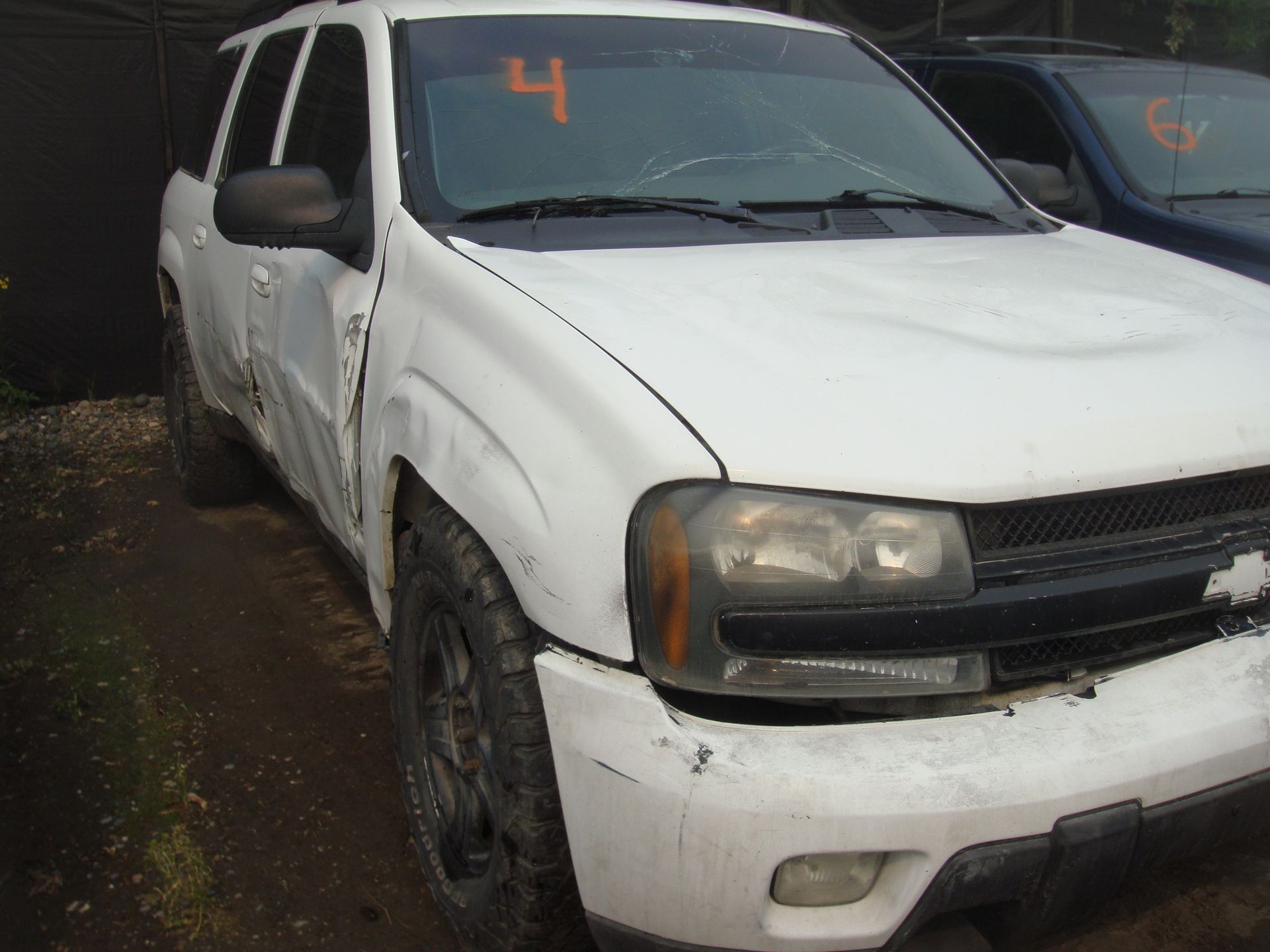A white suv with the number 4 on the windshield