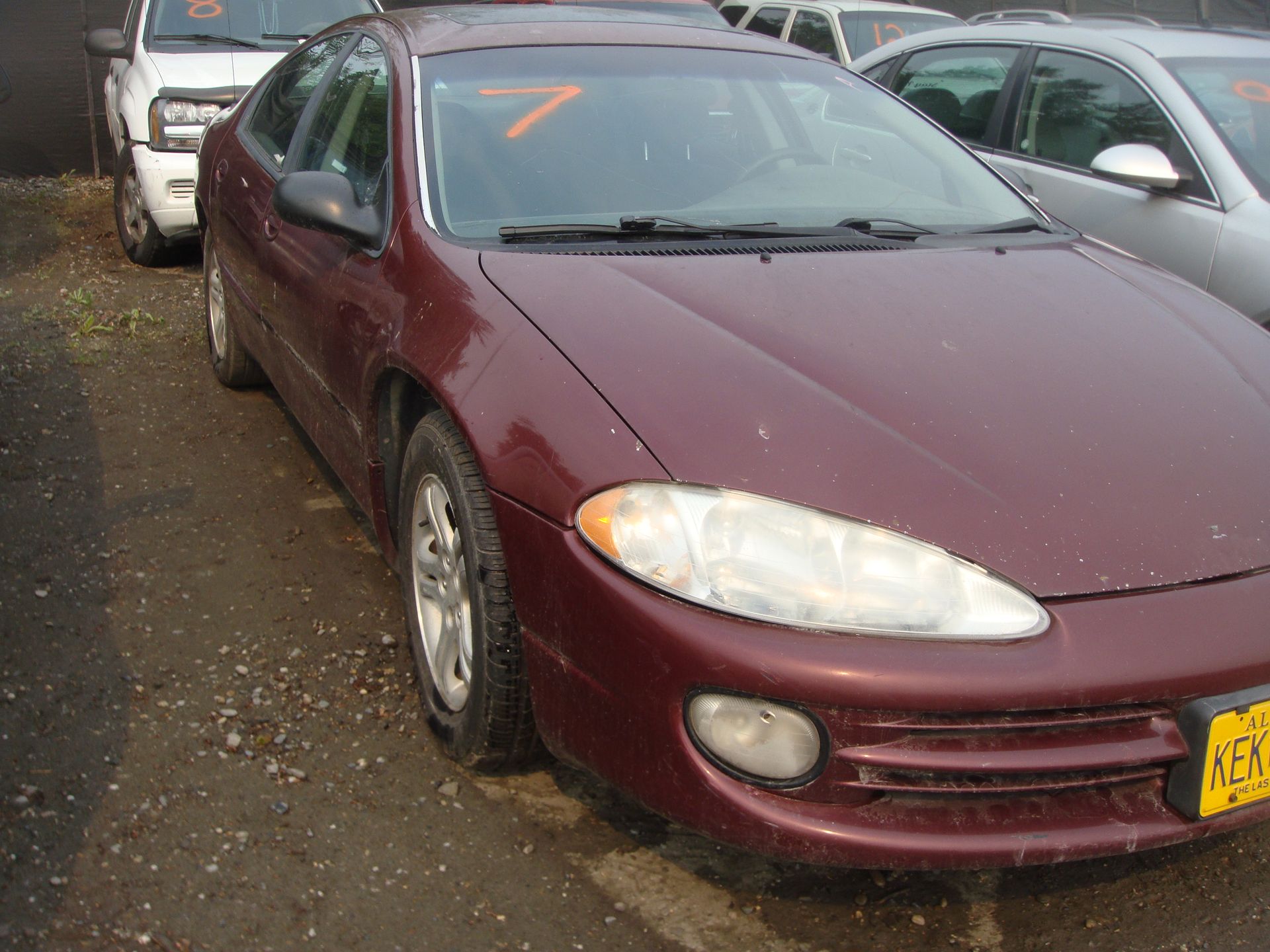 A red car with the number 7 on the windshield