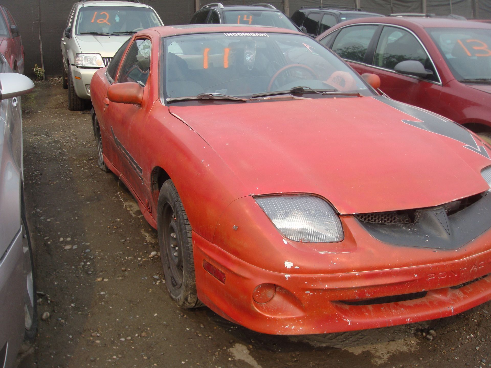 A red car with the number 13 on the back of it