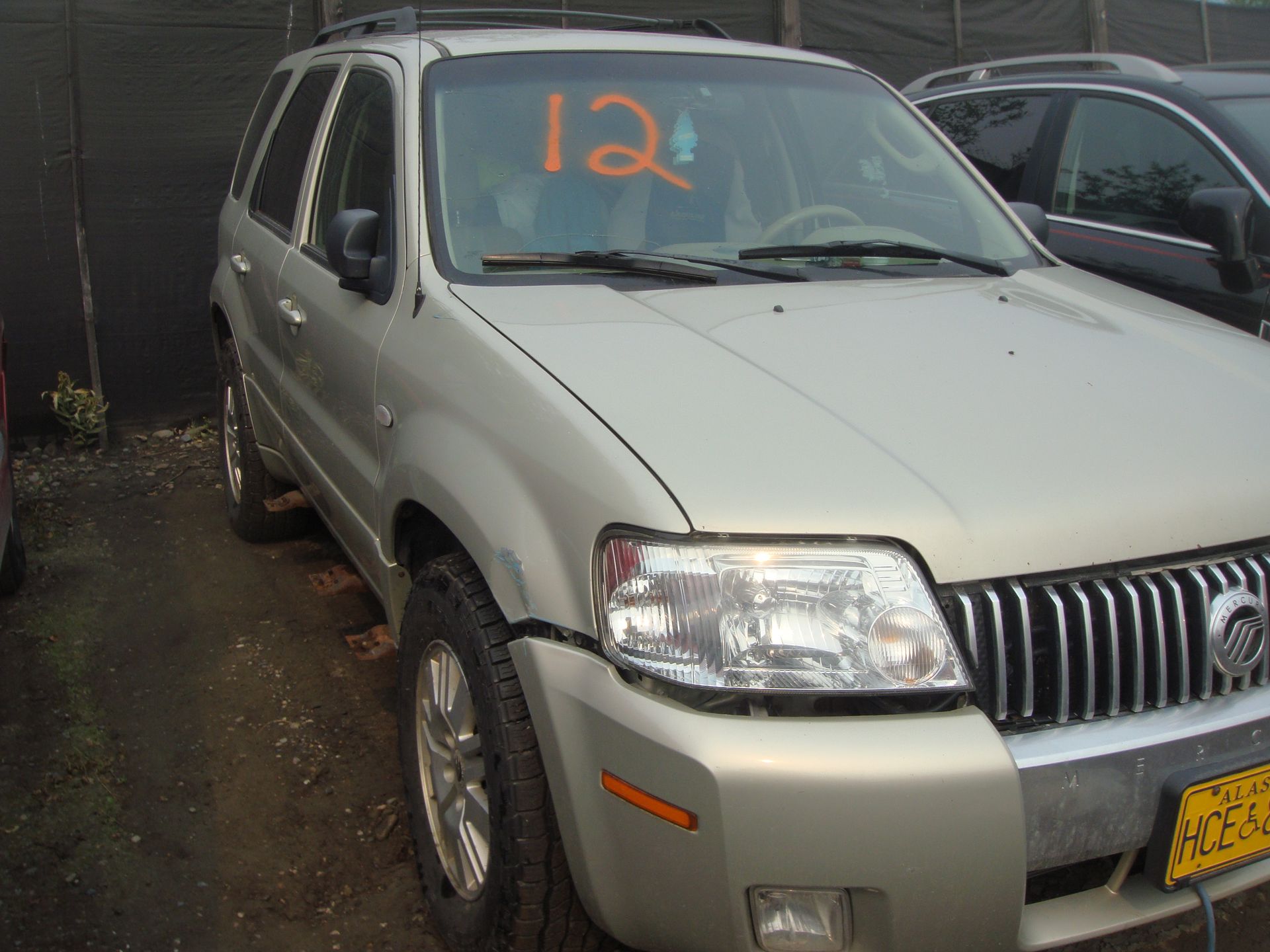 A silver suv with the number 12 on the windshield