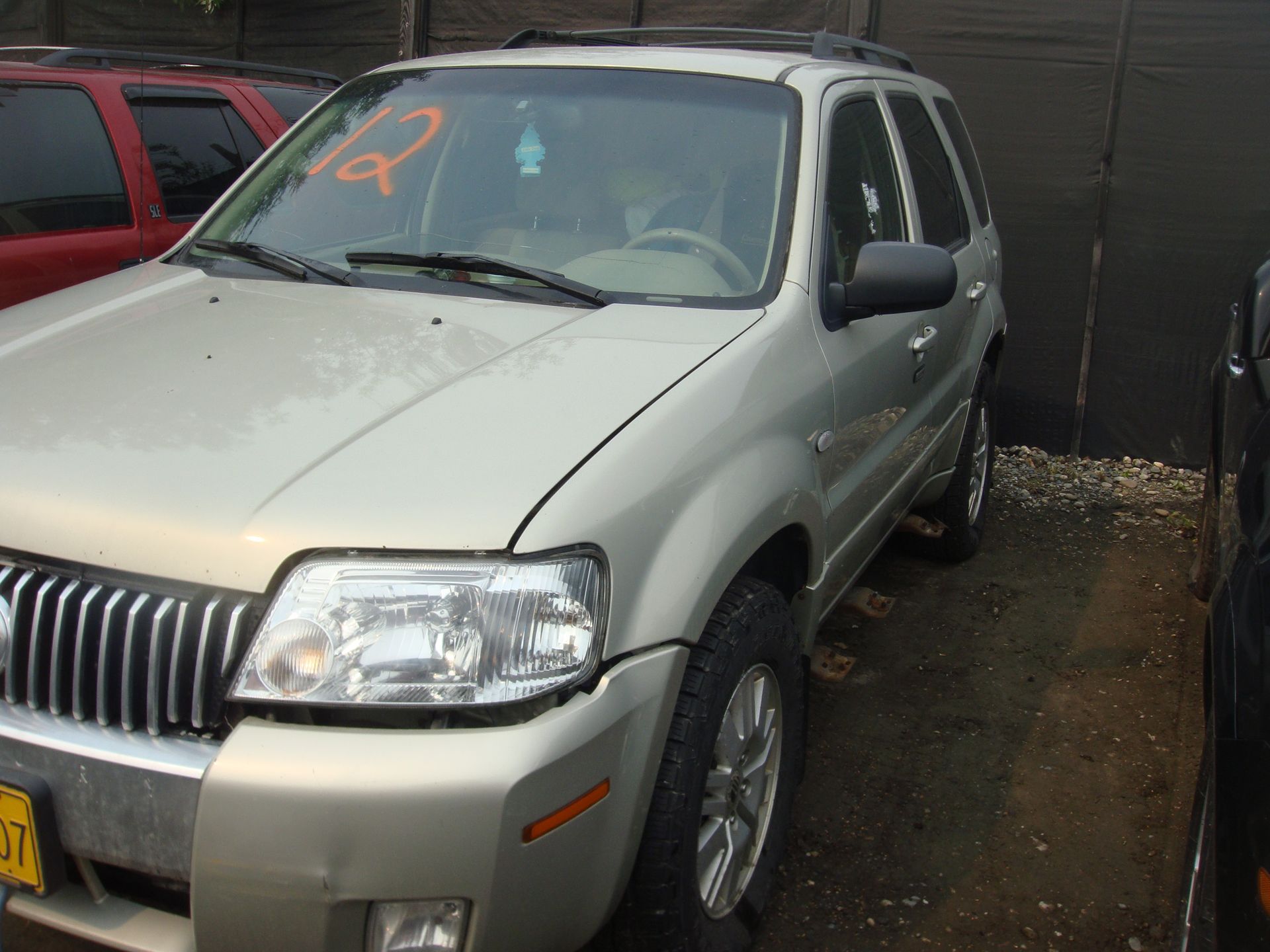 A silver mercury mountaineer is parked in a parking lot