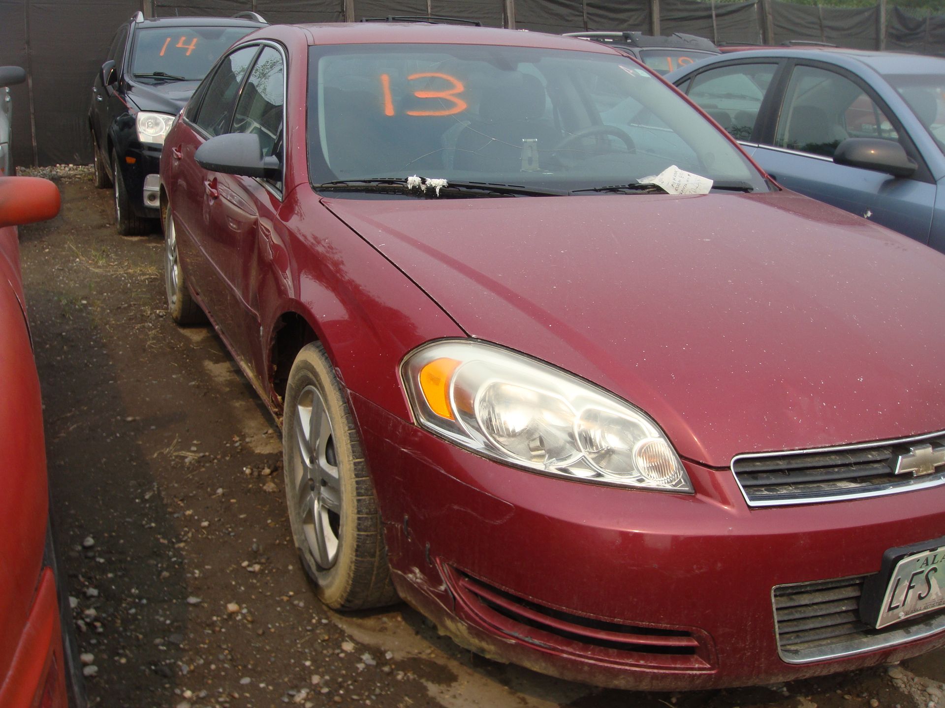 A red car with the number 13 on the windshield