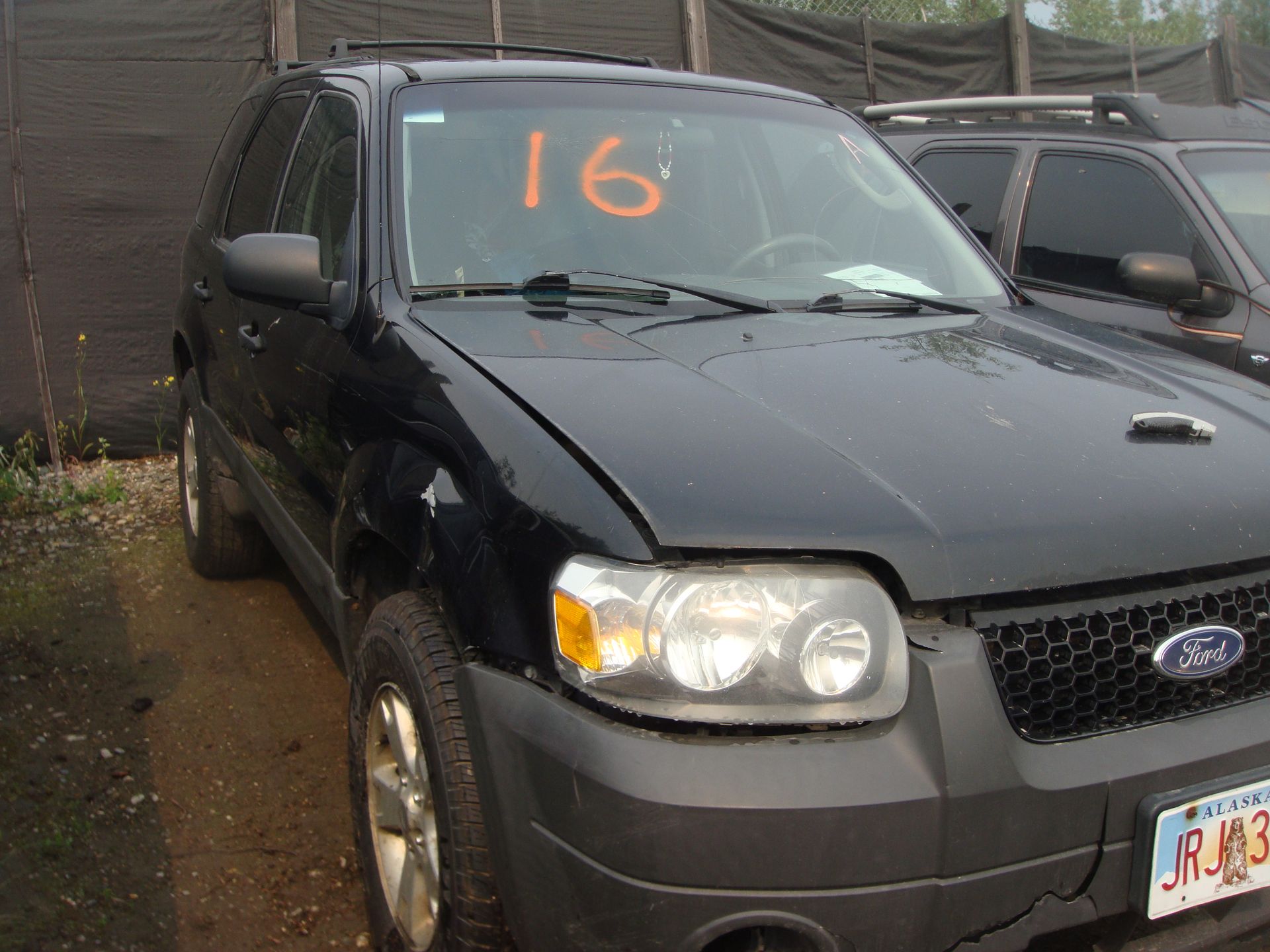 A black ford escape with the number 16 on the windshield