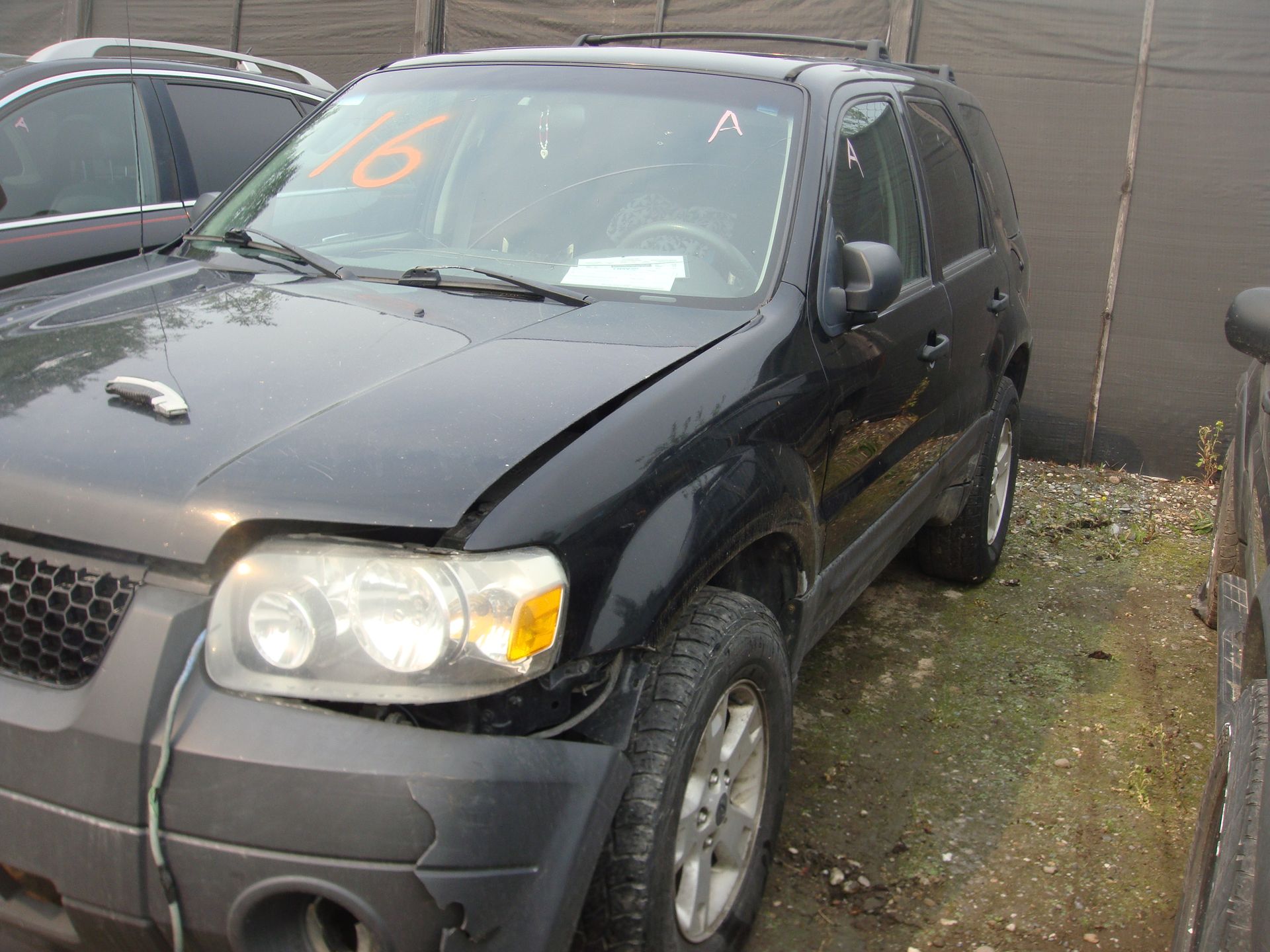 A black ford escape with the number 16 on the windshield