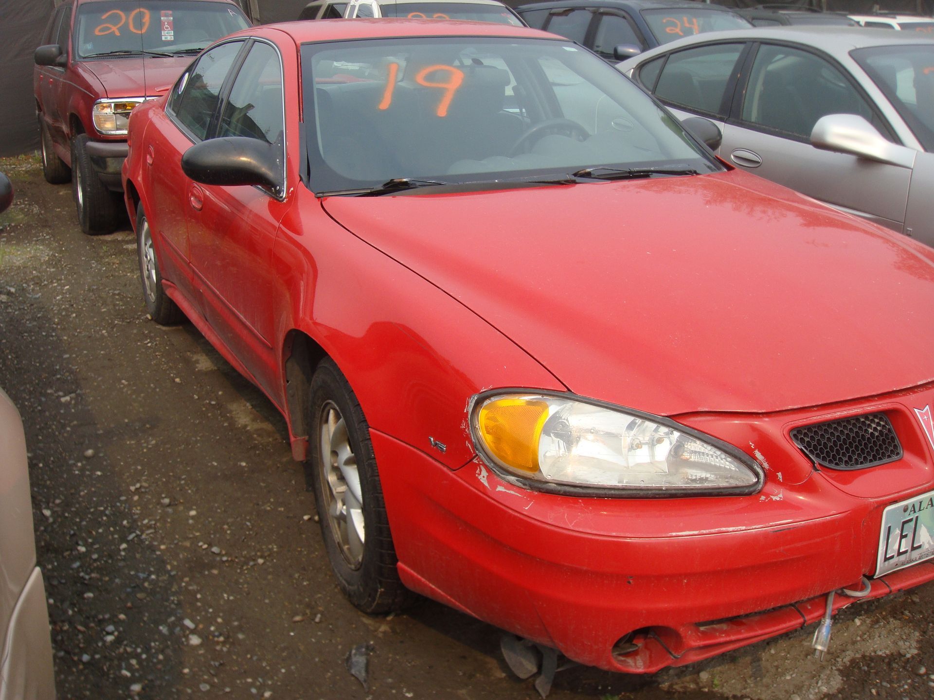 A red car with the number 19 on the hood