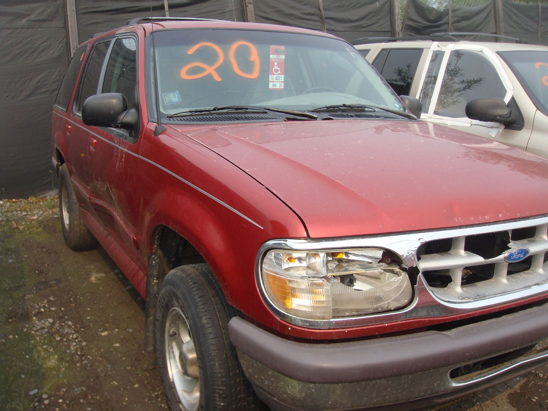A red car with the number 20 on the windshield