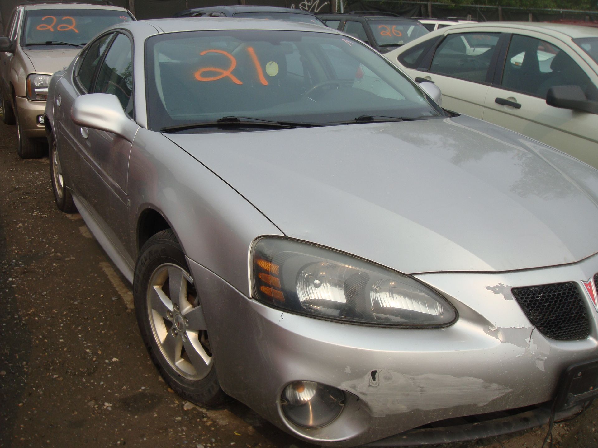 A silver car with the number 21 on the windshield