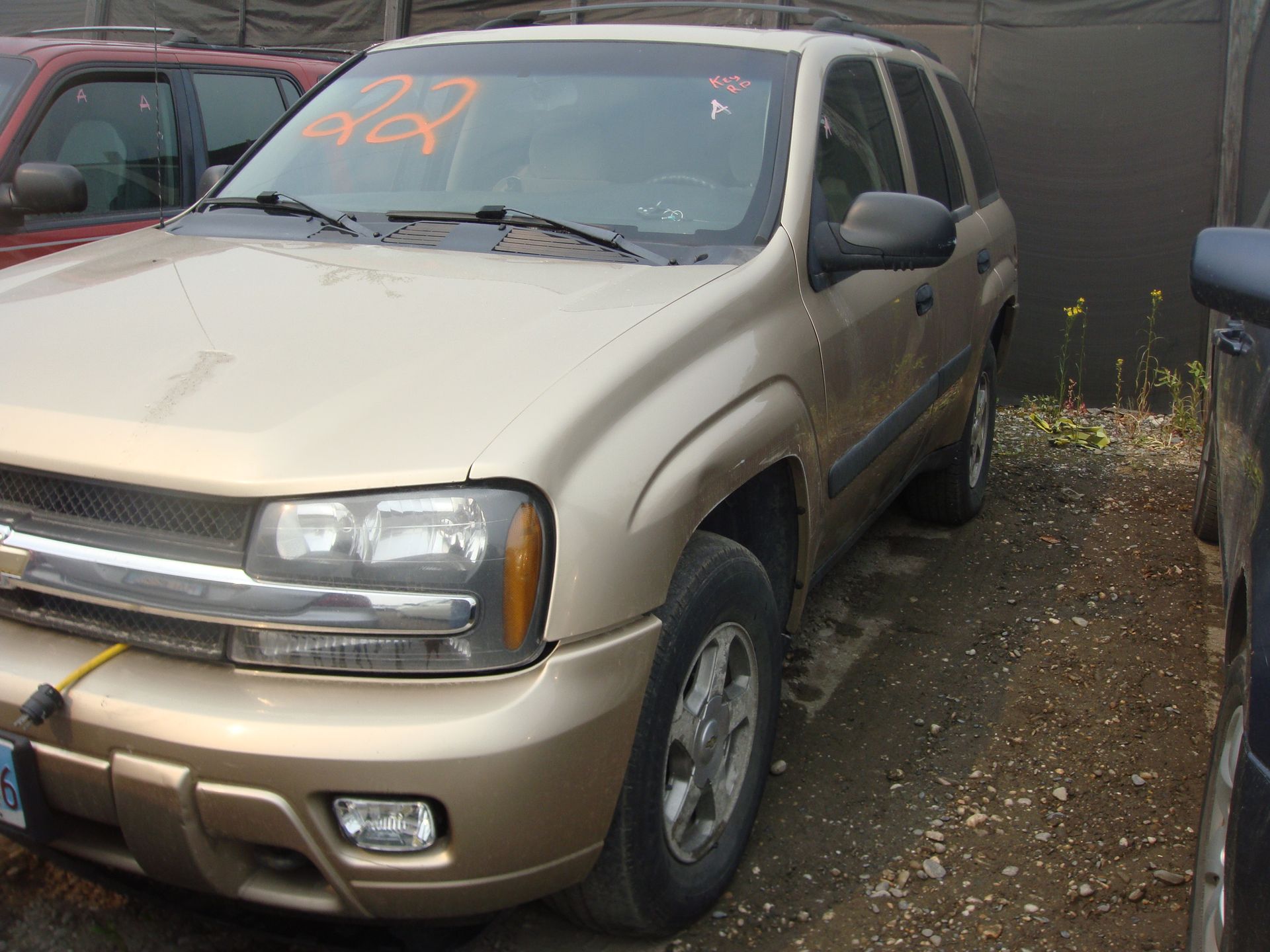 A chevrolet trailblazer is parked in a dirt lot