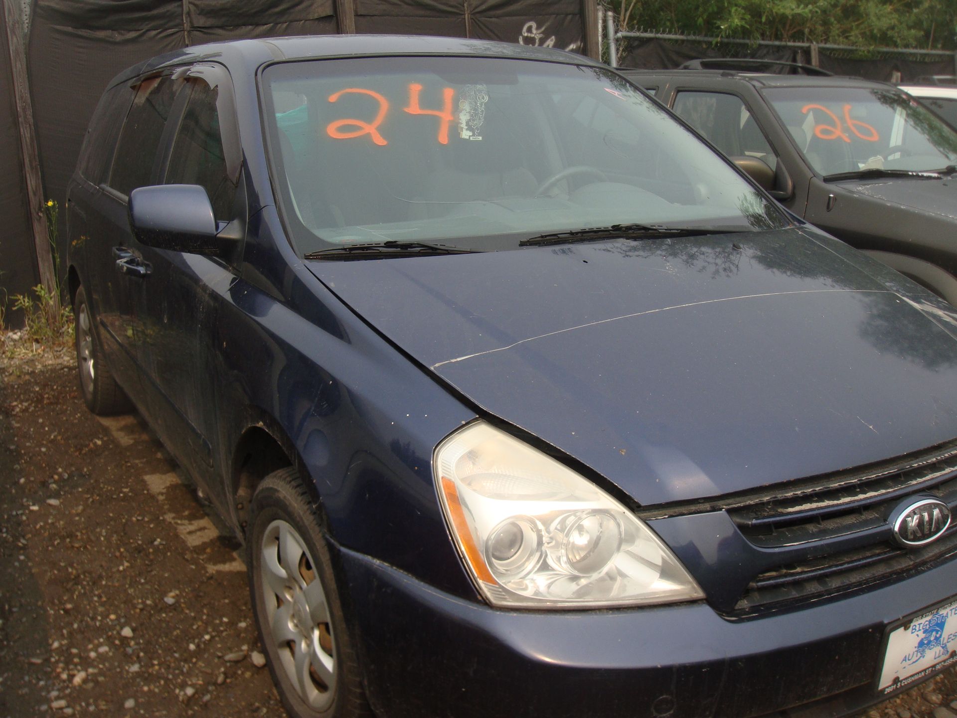 A blue car with the number 24 on the windshield