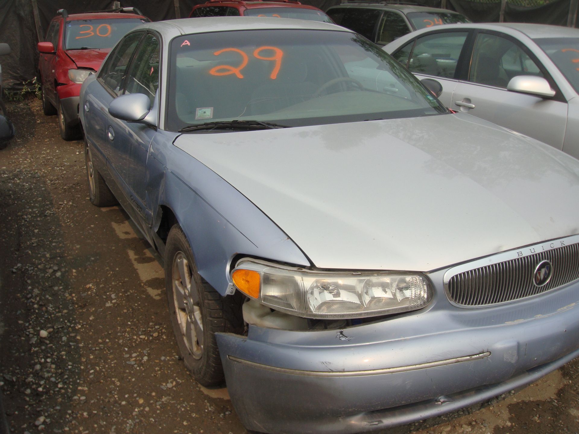 A silver car with the number 29 on the windshield