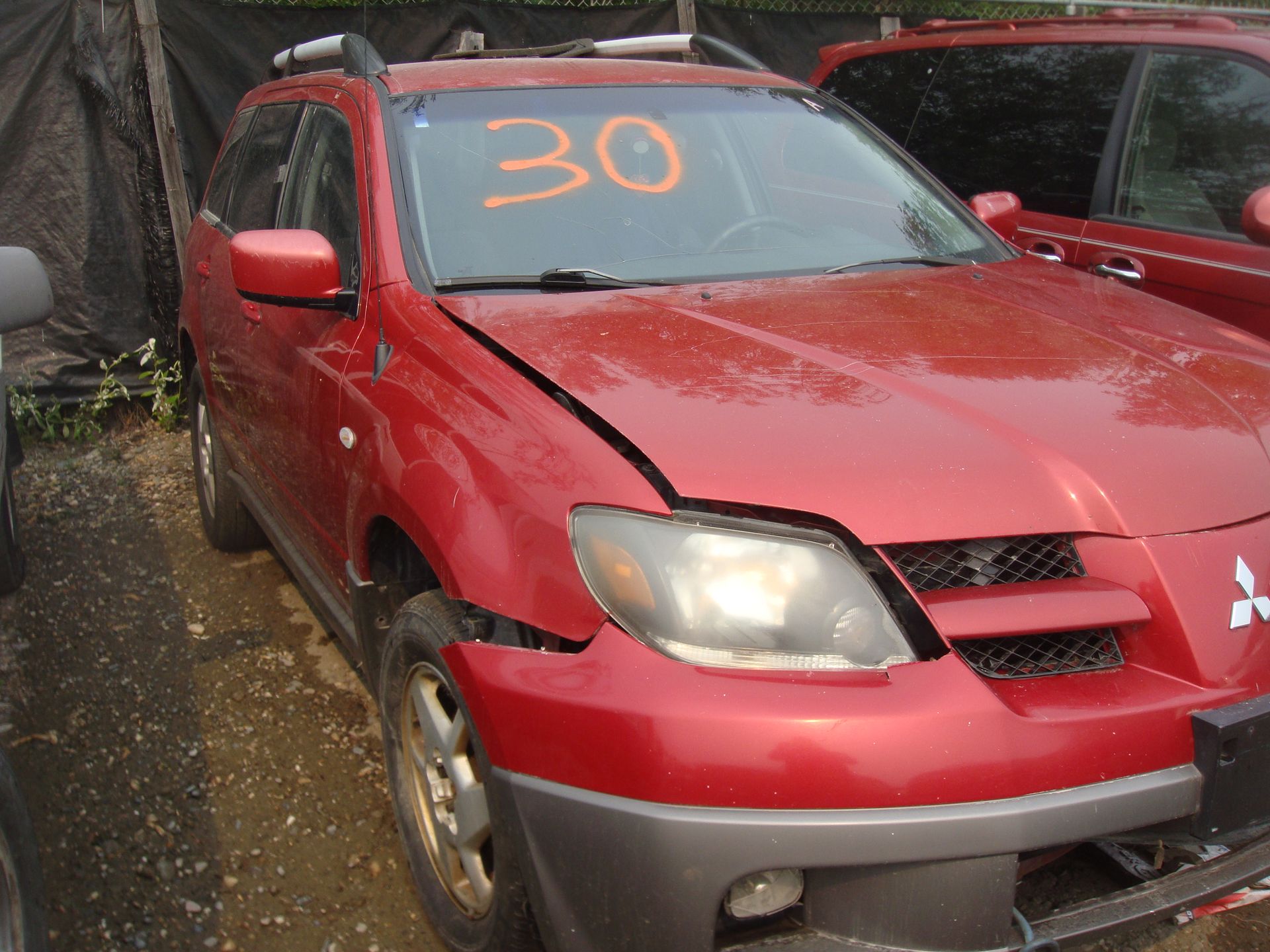A red car with the number 30 on the windshield