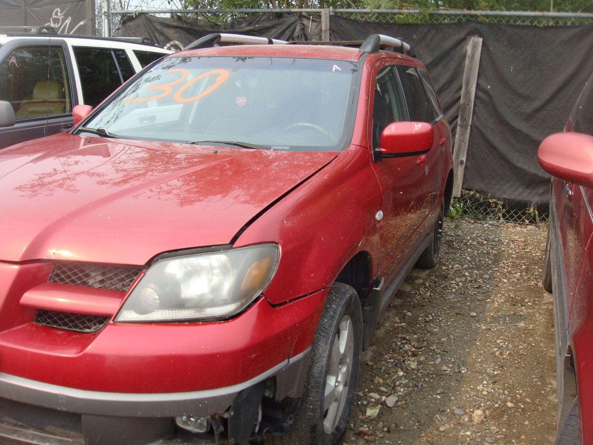 A red car with the number 30 on the windshield