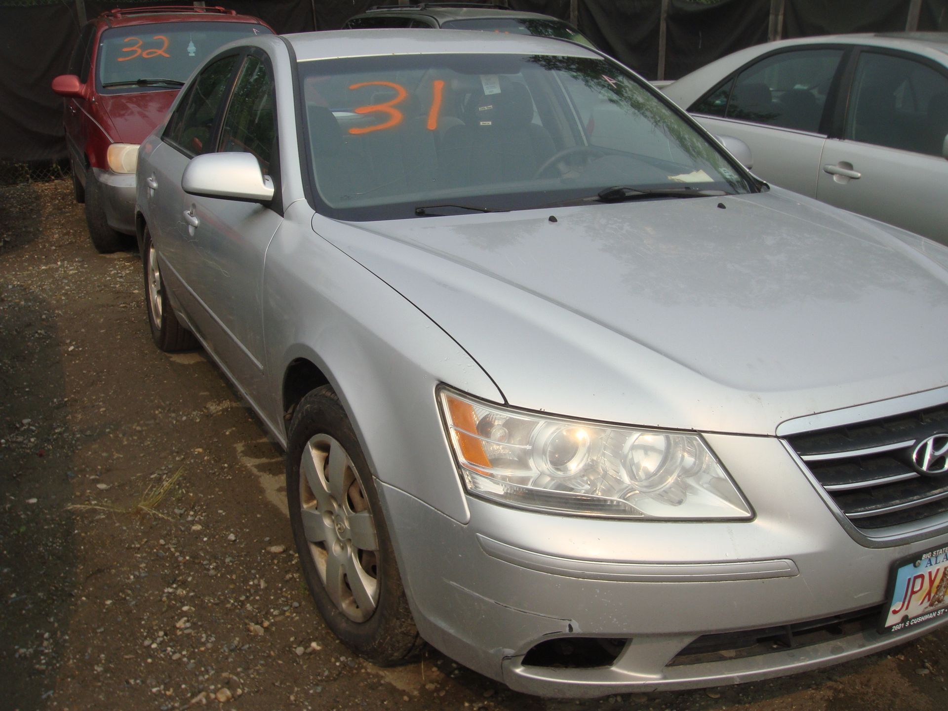 A silver car with the number 31 on the windshield