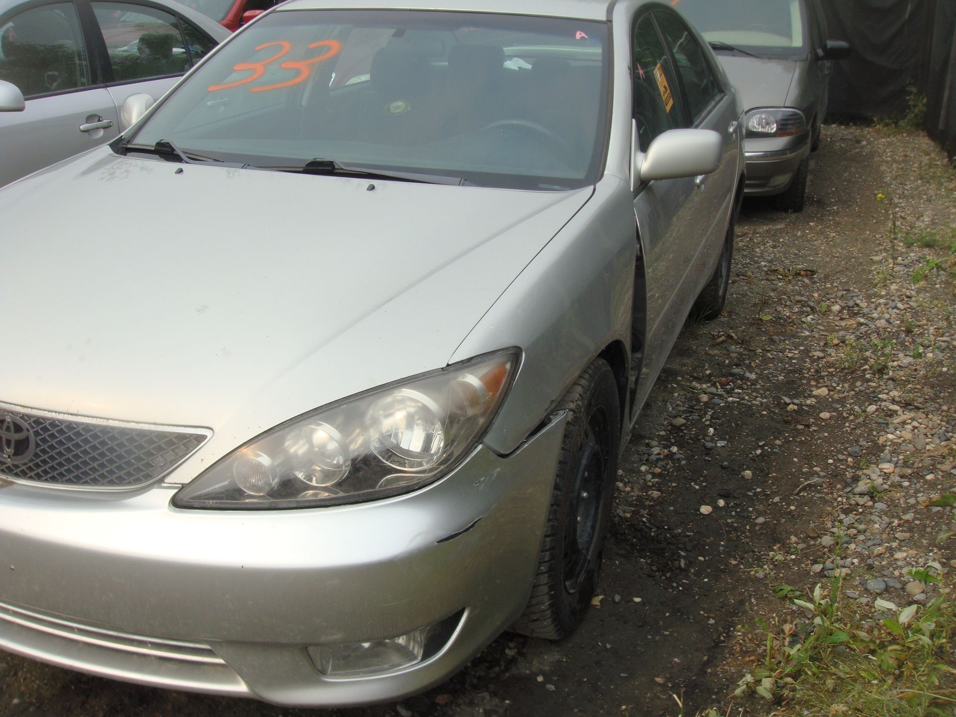 A silver car with the number 38 on the windshield