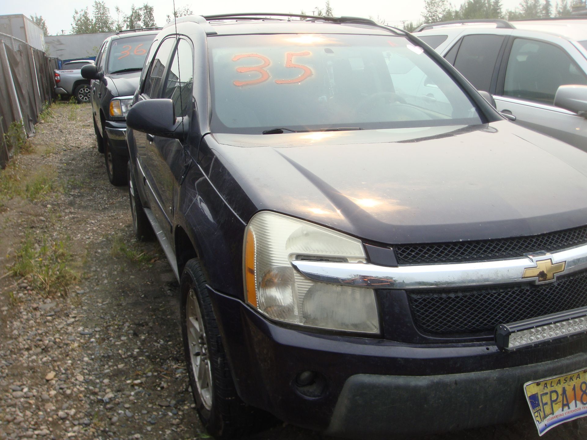 A black suv with the number 35 on the windshield