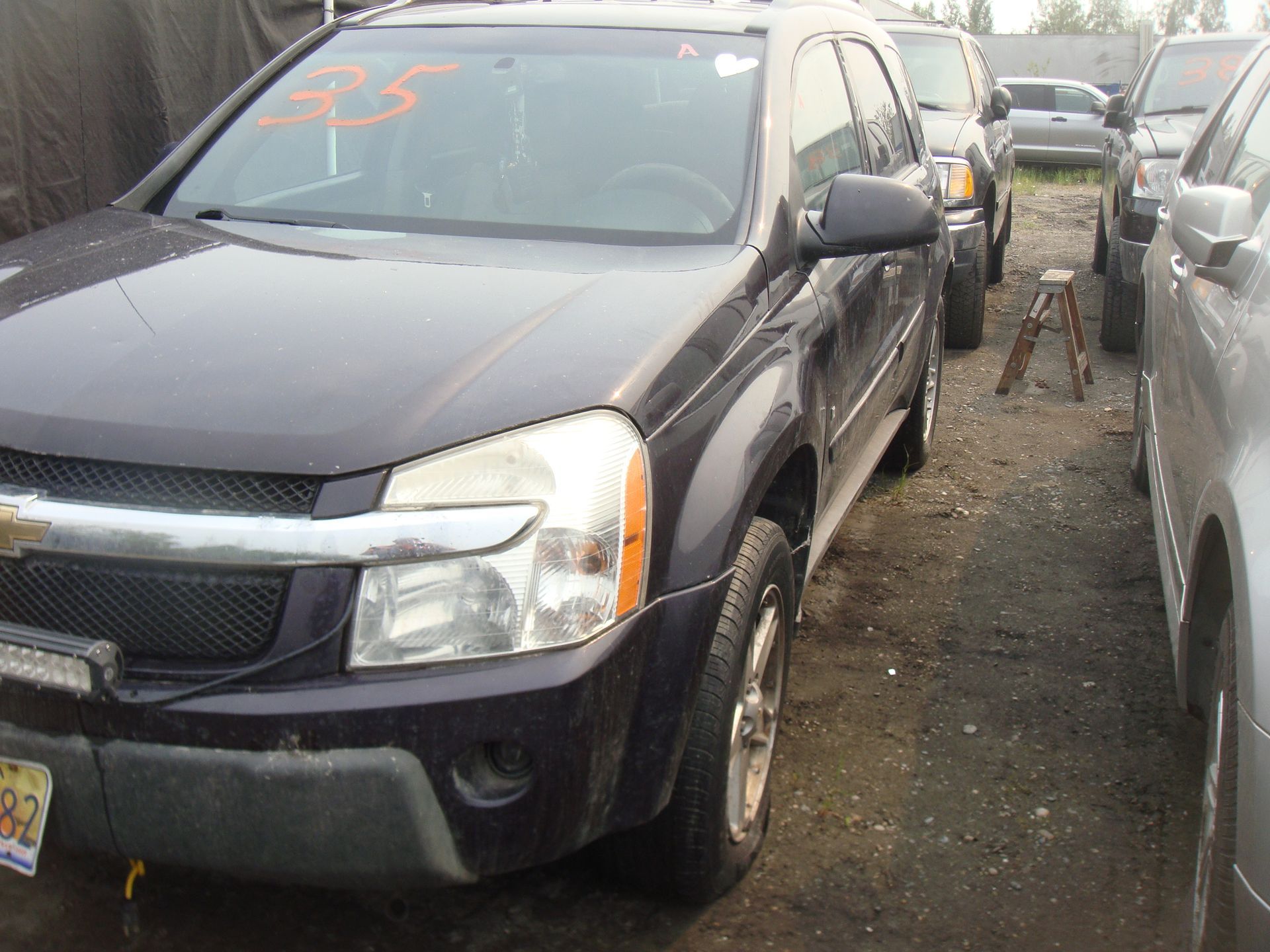 A black suv with the number 35 on the windshield