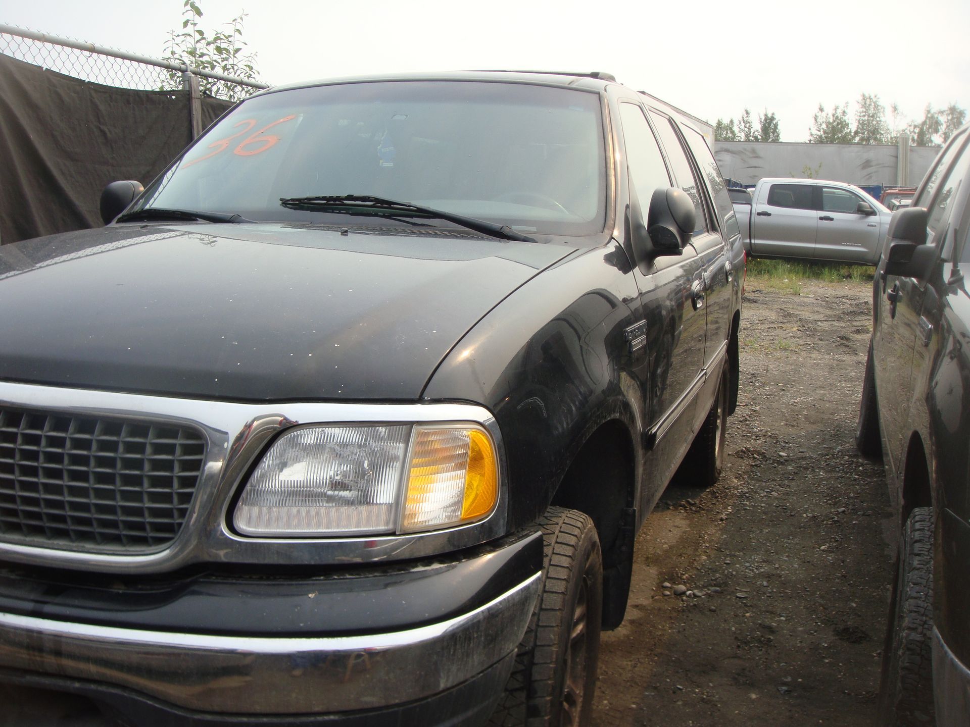 A black ford expedition is parked in a parking lot
