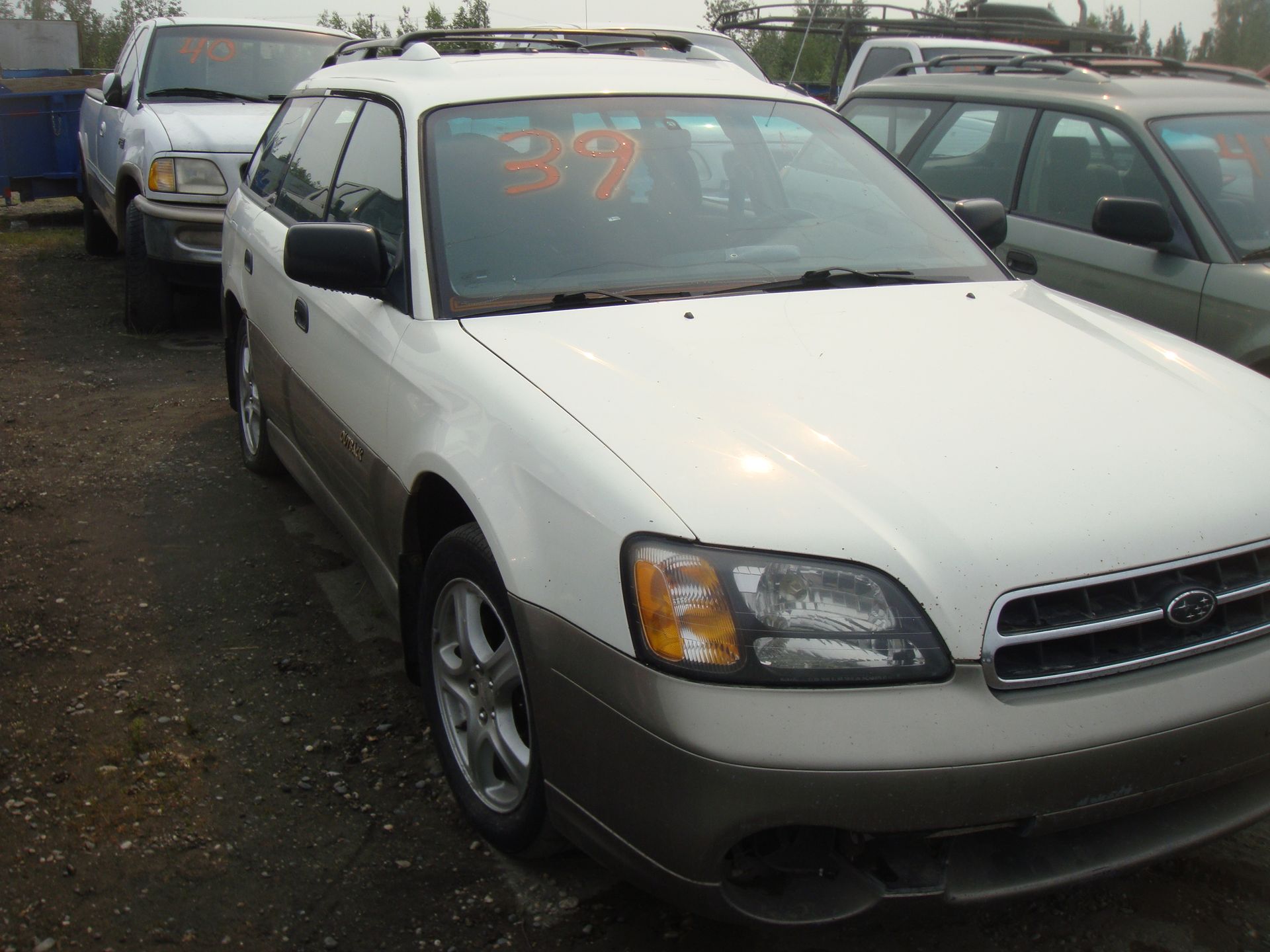 A white car with the number 37 on the windshield