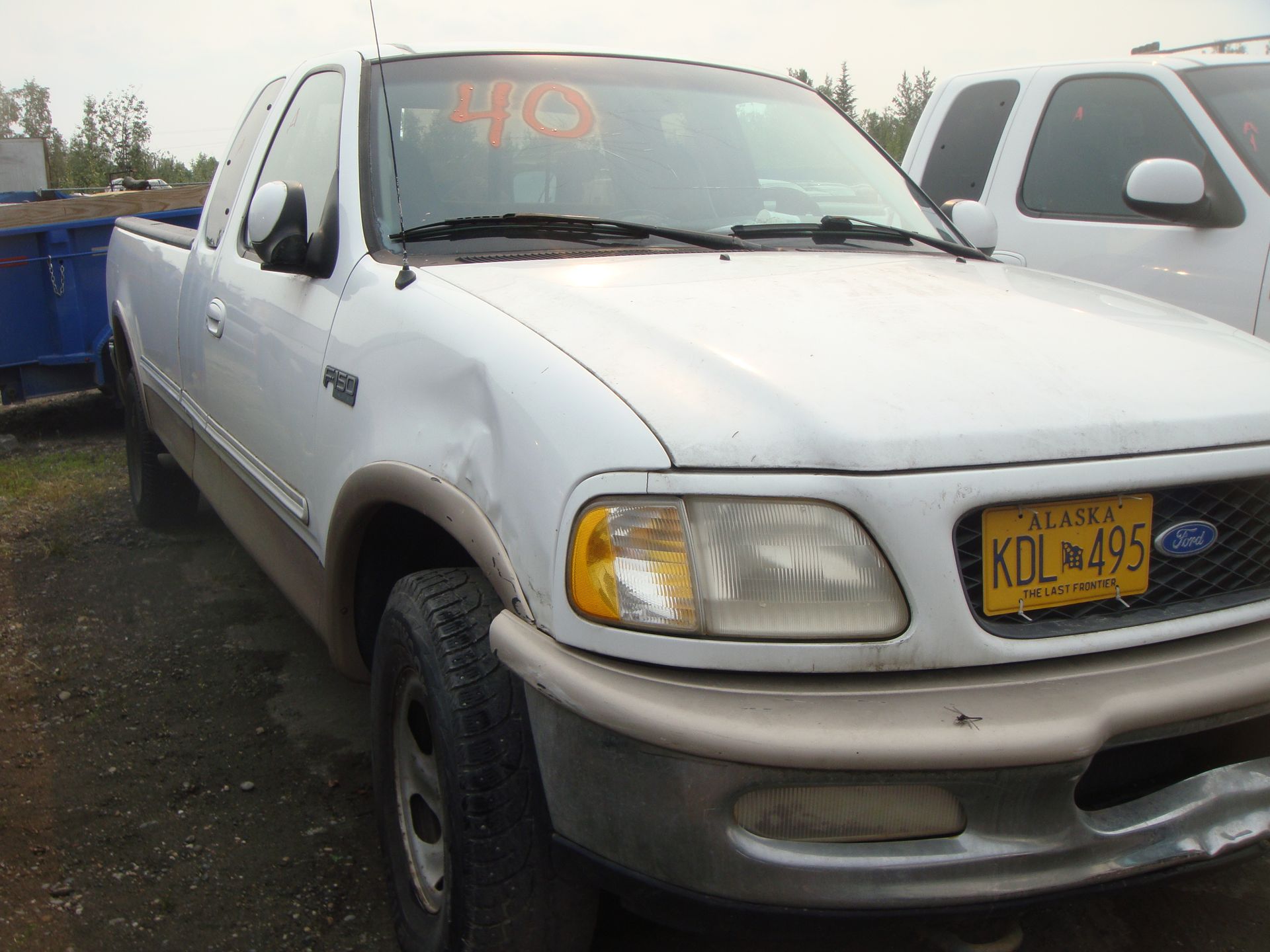 A white ford truck with a new york license plate