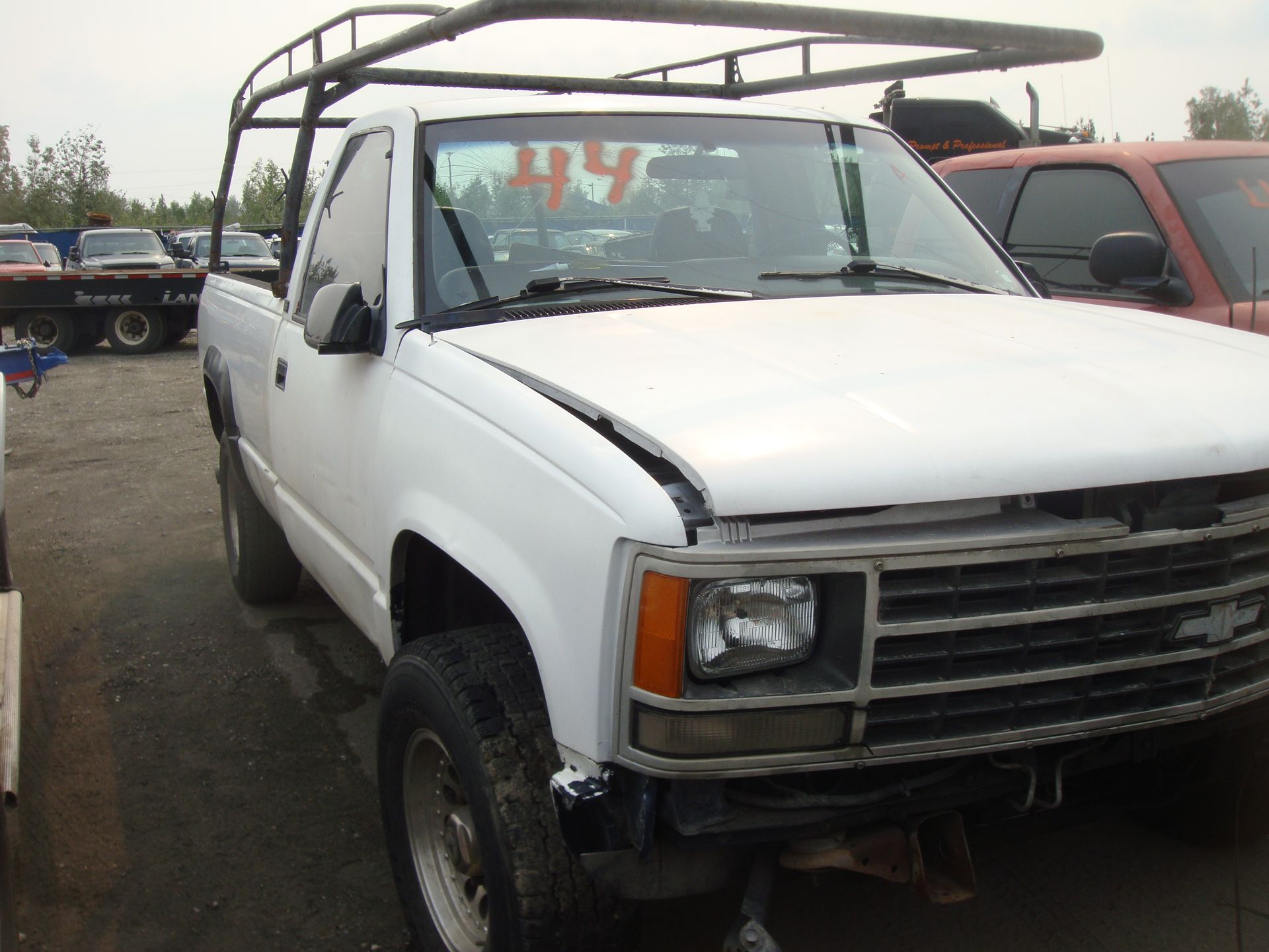 A white truck with the number 44 on the windshield