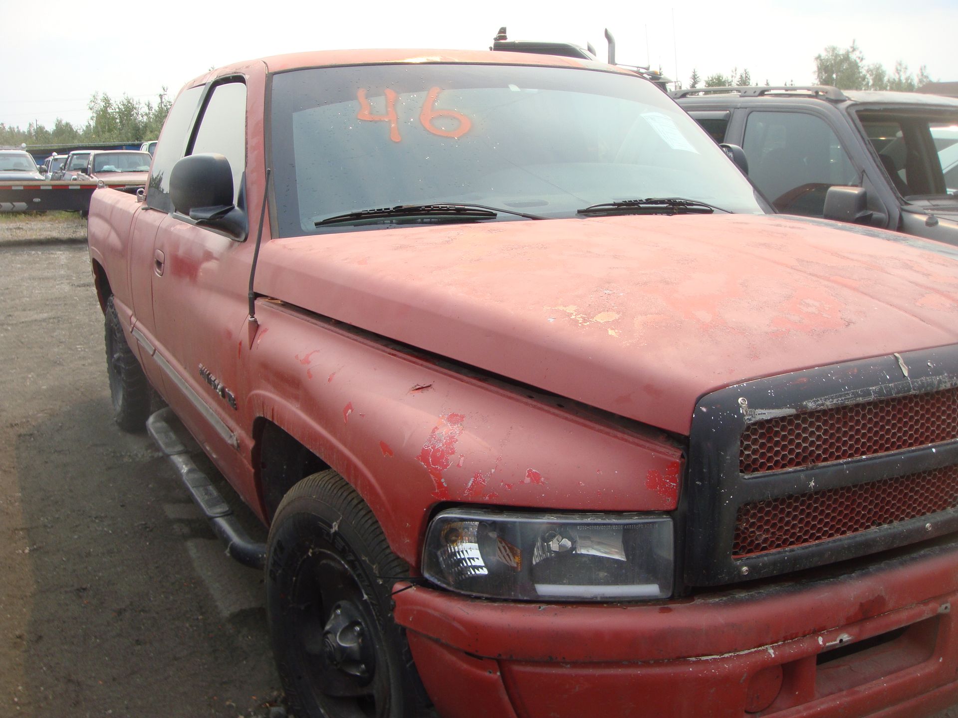 A red truck with the number 46 on the windshield